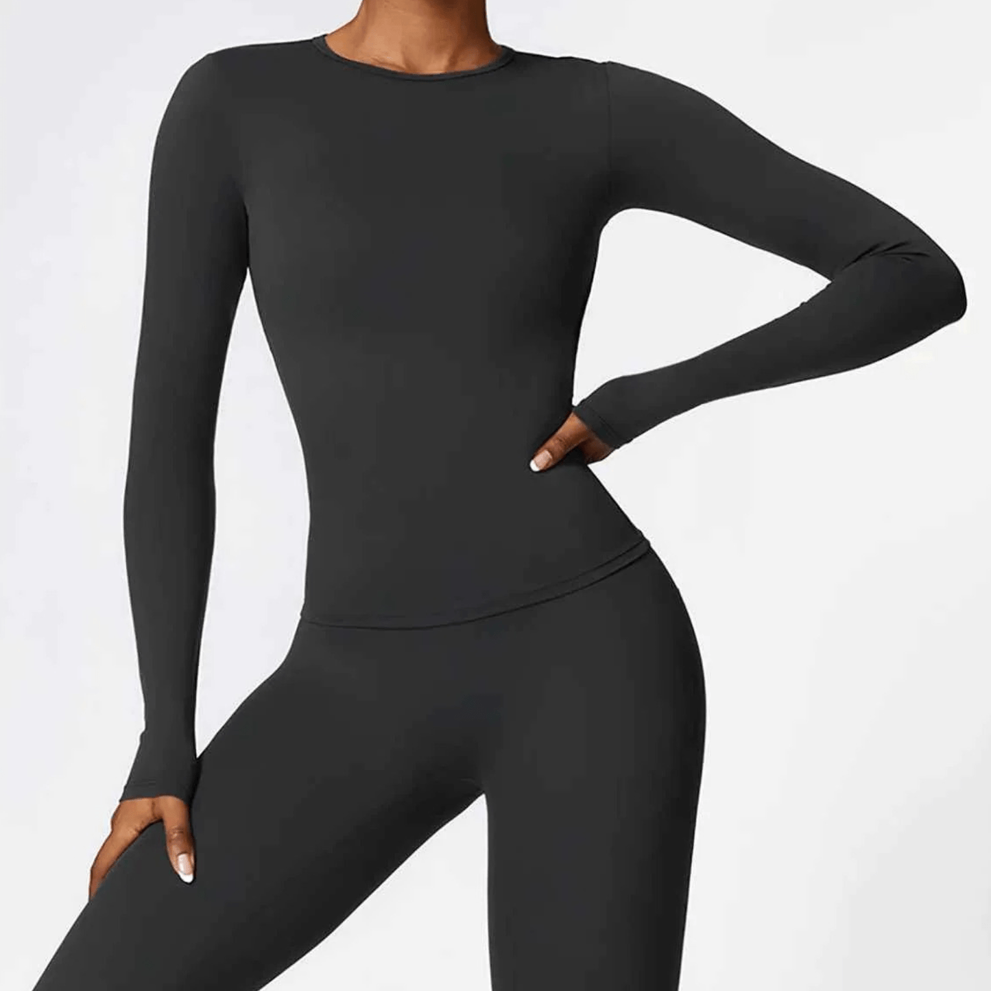 T-shirt compressif à manches longues femme couleur noire, coupe ajustée seconde peau pour sport et fitness
