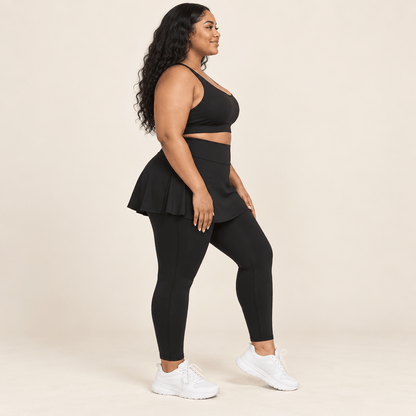 Jupe legging grande taille noire vue de profil, jupe évasée couvrant les hanches