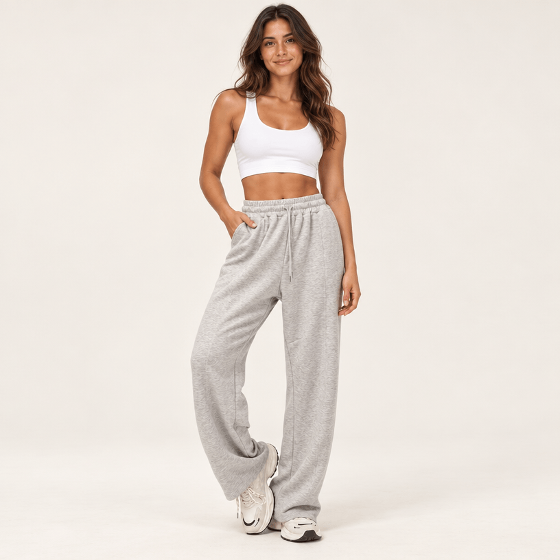 Jogging femme gris chiné à taille haute et jambe large, cordon de serrage et poches latérales, porté de face