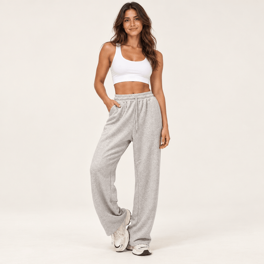 Jogging femme gris chiné à taille haute et jambe large, cordon de serrage et poches latérales, porté de face