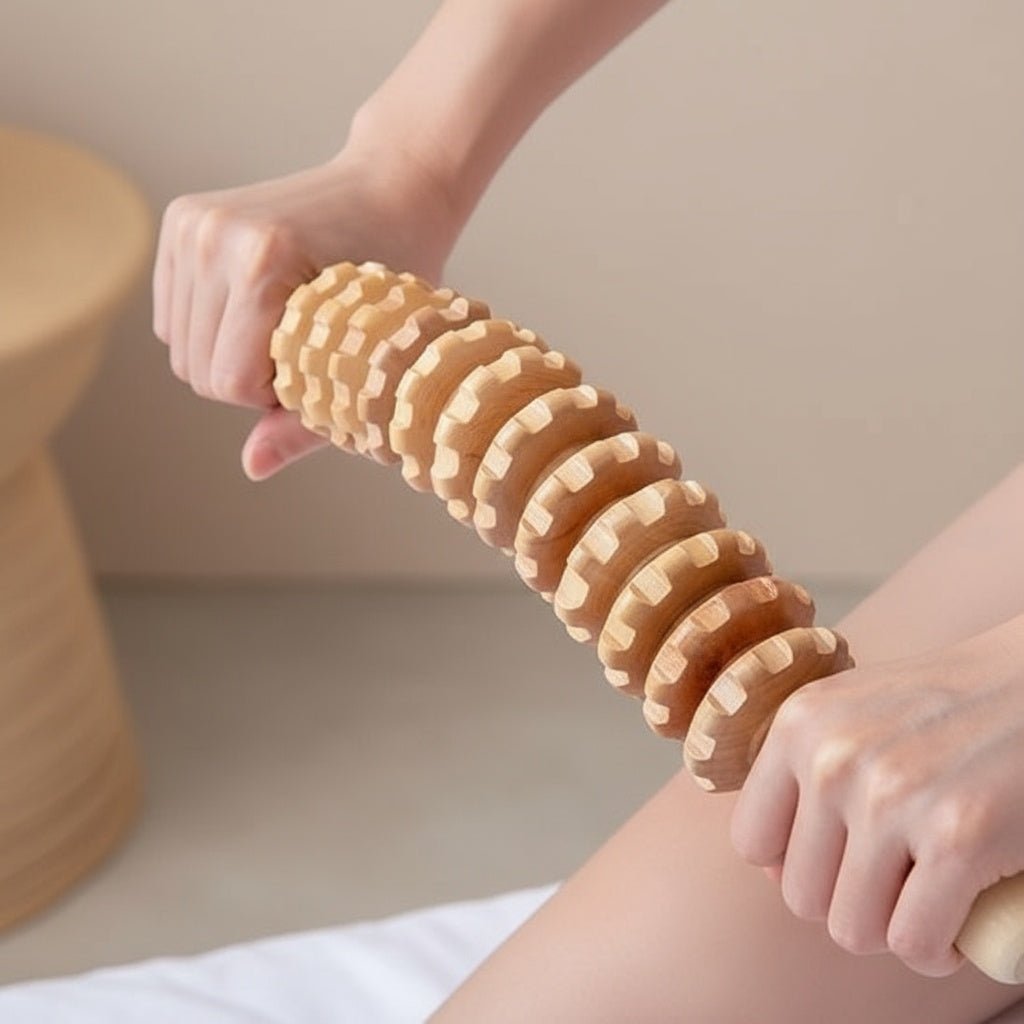 Axe central robuste en métal traversant les rouages mobiles du bâton de massage en bois.