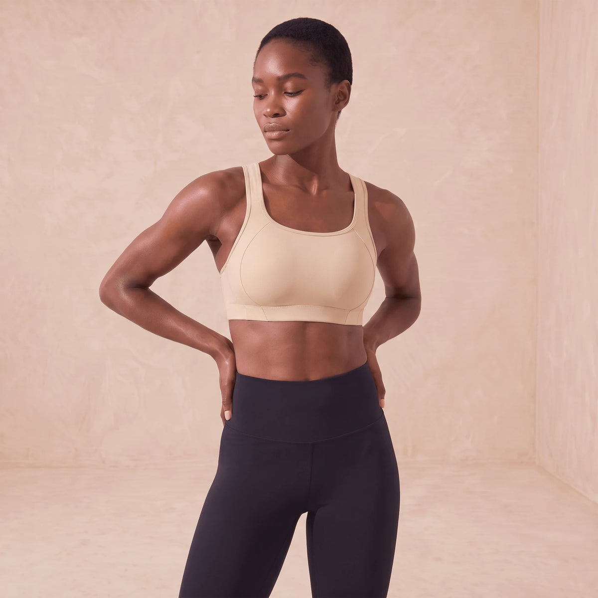 Brassière de sport beige à couverture complète, portée avec un legging noir