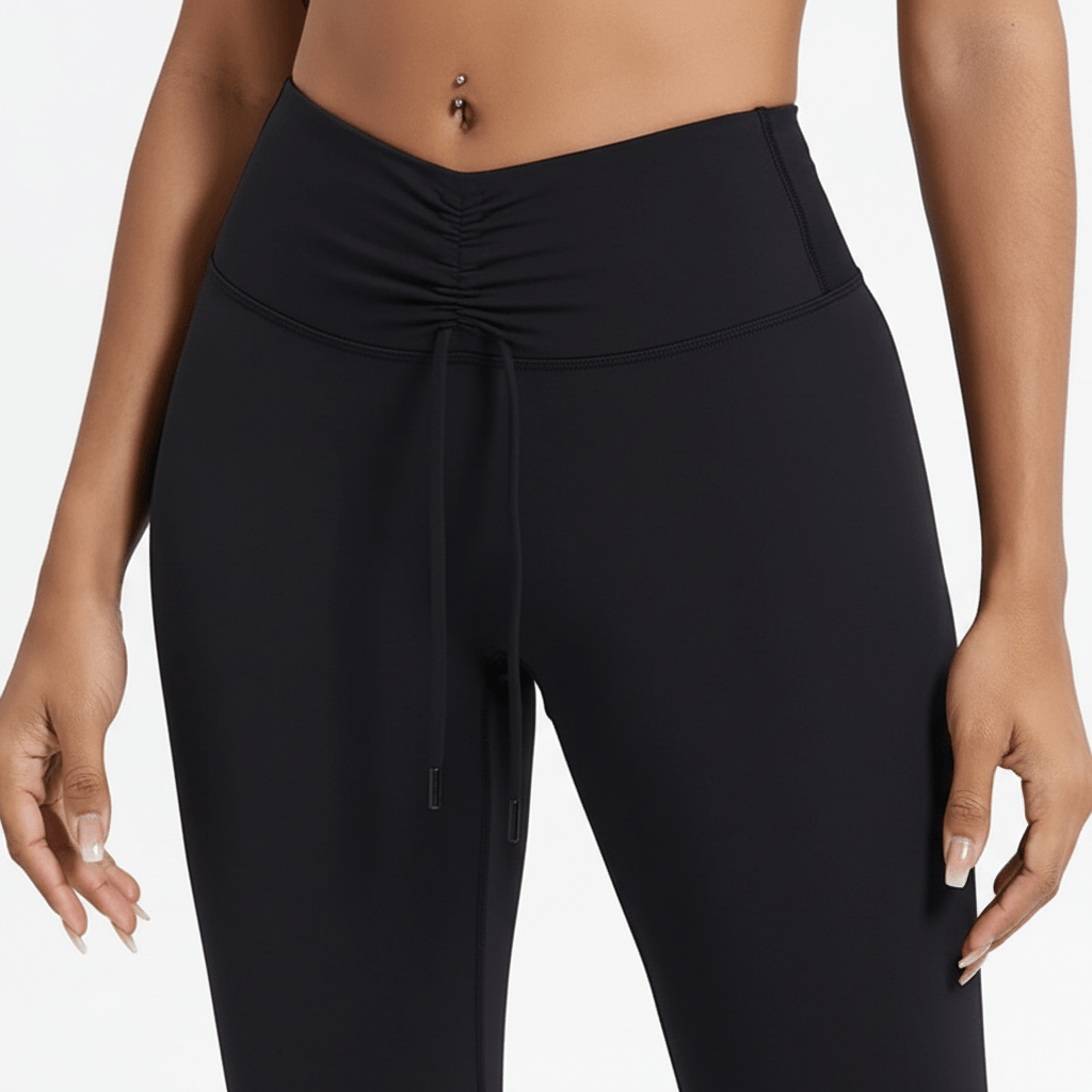 Legging femme Positiflow noir, plan de face mi-cuisse, drapé de ceinture avec cordon, tissu lisse sculptant
