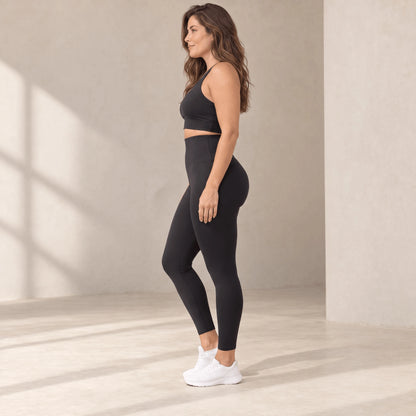 Legging sculptant noir taille haute vu de profil, ceinture haute au-dessus du nombril, longueur cheville
