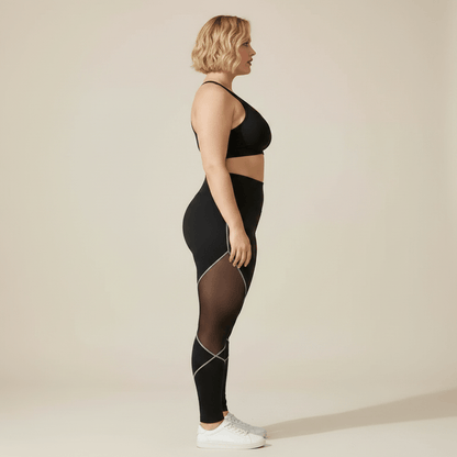 Legging sport grande taille noir taille haute empiècements maille transparente vue de profil debout studio