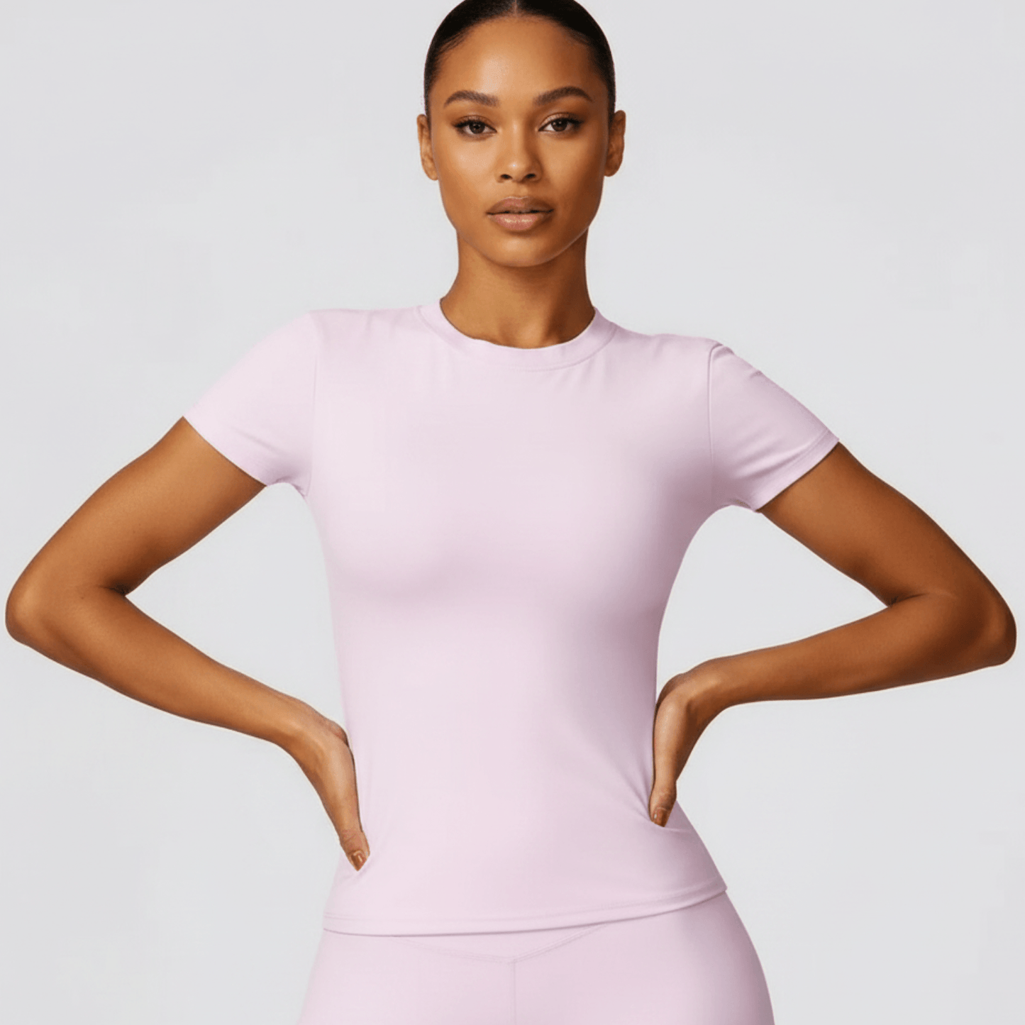 T shirt femme rose positiflow vue de face, design élégant et confortable pour le fitness.