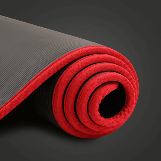 Tapis de gym noir et rouge roulé, packshot premium en studio anthracite minimaliste